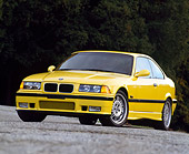 AUT 25 RK0428 02
1995 BMW M-3 Yellow Low 3/4 Front View On Pavement Dark Background