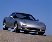 AUT 25 RK0474 08
1992 Mazda RX7 Silver 3/4 Low Front Slanted View On Pavement Hill Blue Sky