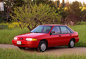 AUT 25 RK0487 01
1993 Ford Escort Red 3/4 Front View By Tall Grass And Trees