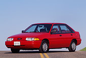 AUT 25 RK0488 01
1993 Ford Escort Red 3/4 Front View On Pavement Blue Sky