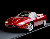 AUT 25 RK0537 07
1997 Jaguar XK8 Convertible Red 3/4 Front View On Gray Line Studio Background