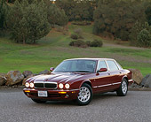 AUT 25 RK0603 03
1998 Jaguar XJ8 Red 3/4 Front View On Pavement By Grass And Trees