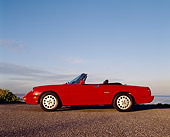 AUT 25 RK0631 05
1994 Alfa Romeo Spider Veloce Convertible Red Profile On Pavement Blue Sky