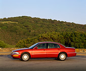 AUT 25 RK0713 04
1999 Buick Park Avenue Red Side View On Pavement Hills Blue Sky