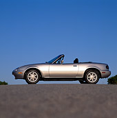 AUT 25 RK0772 03
1990 Mazda Miata Convertible Silver Low Profile View On Pavement Blue Sky