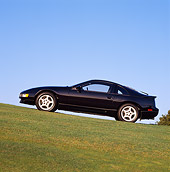 AUT 25 RK0790 02
1990 Nissan 300ZX Turbo Black Slanted Side View On Grass Blue Sky