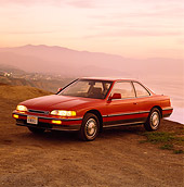 AUT 25 RK0809 04
1990 Acura Legend Red 3/4 Front View On Dirt Mountains Background