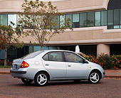 AUT 25 RK0974 03
1997 Toyota Prius Hybrid Light Blue 3/4 Rear View On Pavement By Building