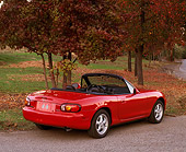 AUT 25 RK0985 05
1999 Mazda Miata MX5 Convertible Red 3/4 Rear View On Pavement By Trees