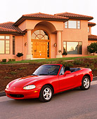 AUT 25 RK0988 07
1999 Mazda Miata MX5 Convertible Red 3/4 Front View On Pavement Hill By House