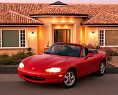 AUT 25 RK0990 04
1999 Mazda Miata MX5 Convertible Red 3/4 Front View On Pavement By House