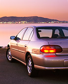 AUT 25 RK1048 01
1999 Chevrolet Malibu Champagne 3/4 Rear View On Sand By Water At Night