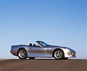 AUT 25 RK1107 03
1999 Shelby Series 1 Convertible Silver Low 3/4 Front View On Pavement Hill Blue Sky