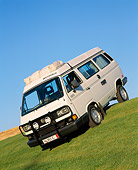 AUT 25 RK1147 11
1990 Volkswagen Syncro Westfalia Vanagon Camper White 3/4 Front Slanted View On Grass Hill Blue Sky