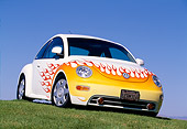 AUT 25 RK1159 06
1998 Volkswagen New Beetle White With Flames Low 3/4 Front View On Grass Blue Sky