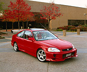 AUT 25 RK1180 04
1999 Honda Civic EX Coupe Red 3/4 Front View On Pavement By Building