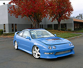 AUT 25 RK1193 02
1998 Acura Integra Baby Blue Front 3/4 View On Pavement By Building