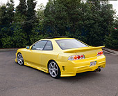 AUT 25 RK1210 01
1999 Honda Prelude SH Yellow Rear 3/4 View On Pavement By Trees