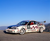 AUT 25 RK1215 02
1997 Acura Integra Type R Race Car #66 White 3/4 Front View On Pavement Blue Sky