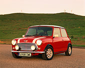 AUT 25 RK1218 03
1998 Mini Cooper European Edition Red And White 3/4 Front View On Pavement By Grass Hill