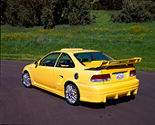 AUT 25 RK1233 02
1998 Honda Civic Custom Yellow 3/4 Rear View On Pavement By Grass Hill