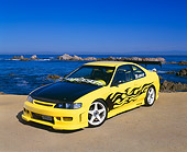 AUT 25 RK1238 01
1994 Honda Accord LX Yellow Black Flames 3/4 Front View On Sand By Ocean