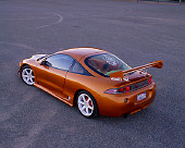AUT 25 RK1293 05
1997 Mitsubishi Eclispe Custom Orange 3/4 Rear View On Pavement