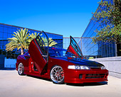 AUT 25 RK1303 02
1997 Acura Integra Red 3/4 Front View Doors Open On Pavement By Glass Building