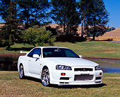 AUT 25 RK1354 04
1999 Nissan Skyline GTR R34 White 3/4 Front View On Grass By Water And Trees