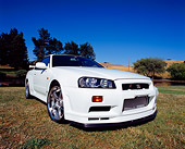 AUT 25 RK1355 04
1999 Nissan Skyline GTR R34 White Wide Angle 3/4 Front View On Grass