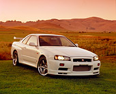 AUT 25 RK1368 01
1999 Nissan Skyline GTR R34 White 3/4 Front View On Grass Filtered