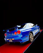 AUT 25 RK1396 02
1999 Nissan Skyline GTR Blue Slanted 3/4 Rear View On Red Floor Gray Line Studio