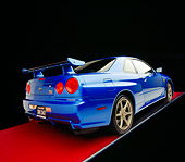 AUT 25 RK1397 04
1999 Nissan Skyline GTR Blue 3/4 Rear View On Red Floor Gray Line Studio