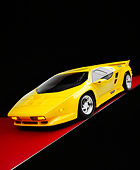 AUT 25 RK1400 08
1992 Vector W8 Yellow Slanted 3/4 Front View On Red Floor Studio
