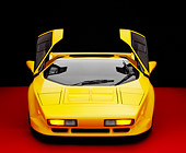 AUT 25 RK1406 16
1992 Vector W8 Yellow Head On View Doors Open On Red Floor Studio