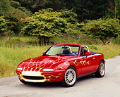 AUT 25 RK1410 03
1990 Mazda Miata Convertible Red With Flames Front 3/4 View On Pavement By Trees