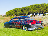 AUT 26 BK0001 01
1951 Chevrolet Fleetline Hot Rod Black With Red Flames 3/4 Front View On Grass By Trees