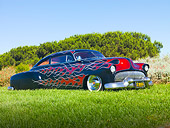 AUT 26 BK0002 01
1951 Chevrolet Fleetline Hot Rod Black With Red Flames 3/4 Front View On Grass By Trees