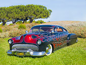 AUT 26 BK0003 01
1951 Chevrolet Fleetline Hot Rod Black With Red Flames 3/4 Front View On Grass By Trees