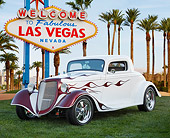 AUT 26 BK0011 01
1934 Ford White With Purple Flames 3/4 Front View On Grass By Las Vegas Sign