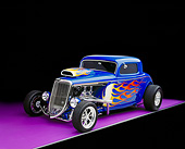 AUT 26 RK0336 08
1934 Ford 3 Window Coupe Blue With Flames 3/4 Front View On Purple Floor Gray Line Studio