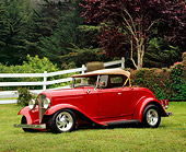 AUT 26 RK0561 02
1932 Ford Roadster Red 3/4 Front View On Grass By White Fence And Trees