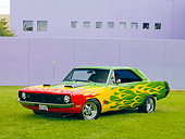 AUT 26 RK2806 01
1970 Dodge Dart Swinger Hot Rod Red, Yellow, Green 3/4 Front View On Grass By Building