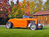 AUT 26 RK2915 01
1932 Ford Hi-Boy Roadster Hot Rod Orange 3/4 Front View On Grass By Barn