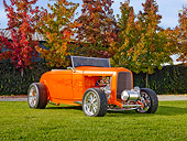 AUT 26 RK2916 01
1932 Ford Hi-Boy Roadster Hot Rod Orange 3/4 Front View On Grass By Trees