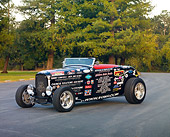 AUT 26 RK2922 01
1932 Ford Roadster Hot Rod Black With Decals 3/4 Front View On Pavement By Trees