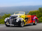 AUT 26 RK3038 01
1939 Ford Pickup Hot Rod Yellow, Orange And Pink With Black Flames 3/4 Front View On Pavement By Trees