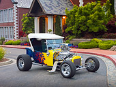 AUT 26 RK3043 01
1923 Ford T-Bucket Hot Rod Blue With Yellow Flames 3/4 Front View On Pavement By House