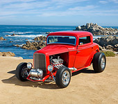 AUT 26 RK3111 01
1932 Ford 3 Window Coupe Bright Red 3/4 Front View On Sand By Ocean