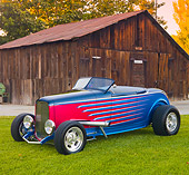 AUT 26 RK3215 01
1932 Ford Roadster Multi-Colored 3/4 Front View On Grass By Old Barn